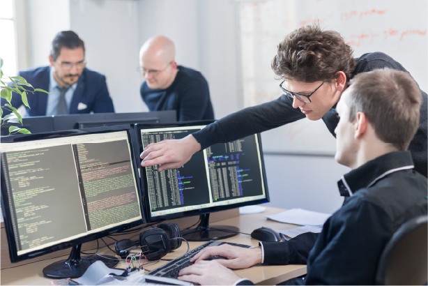 Two men working on code