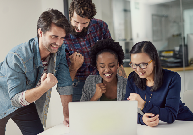 Four people at a computer